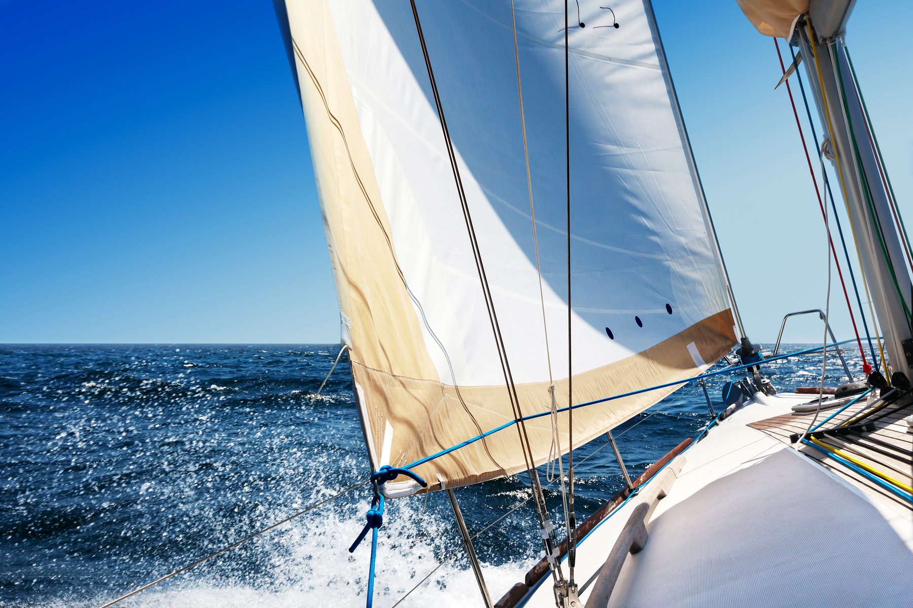 Sailboat heeling under full sail on open water